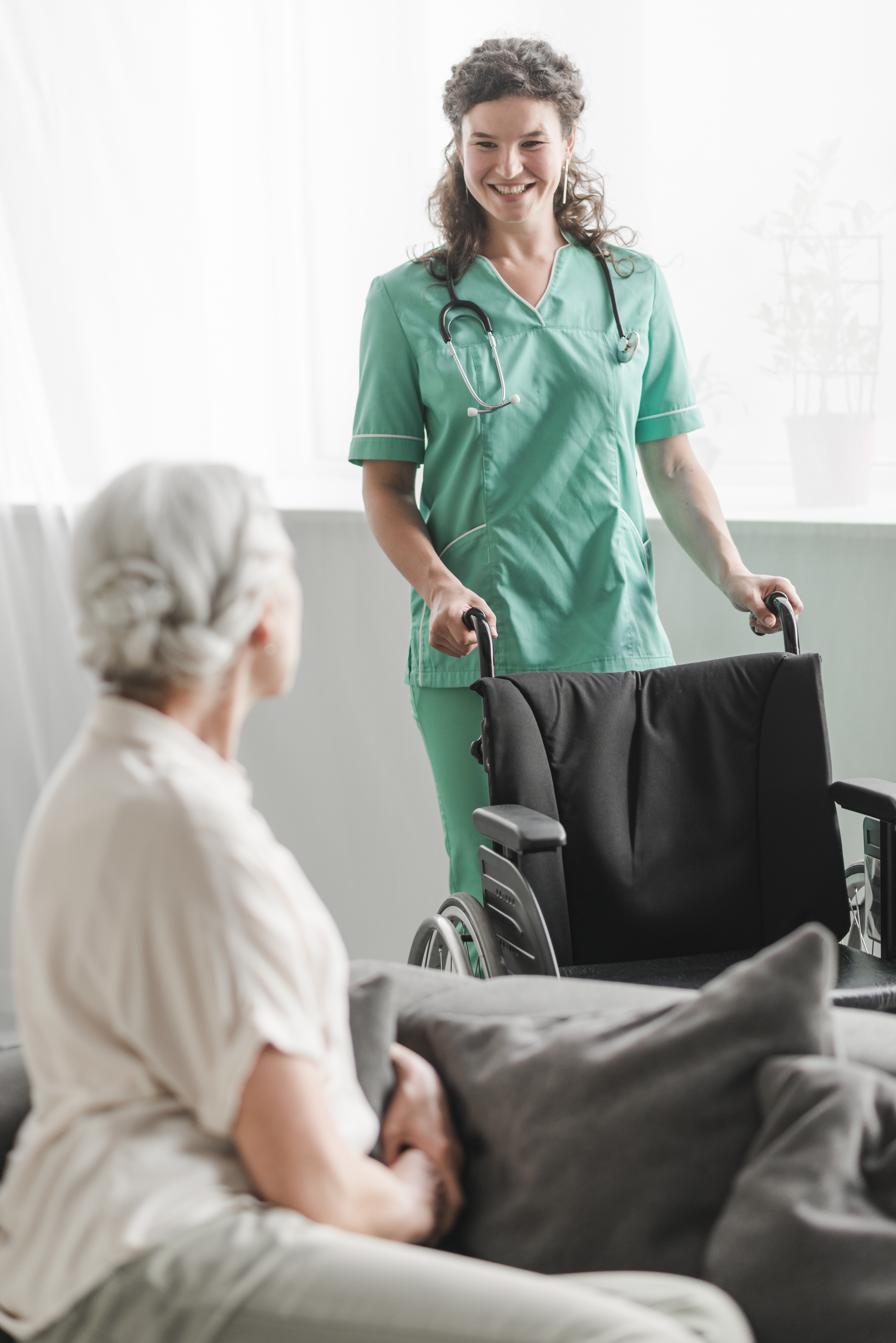 Care worker assisting elderly patient